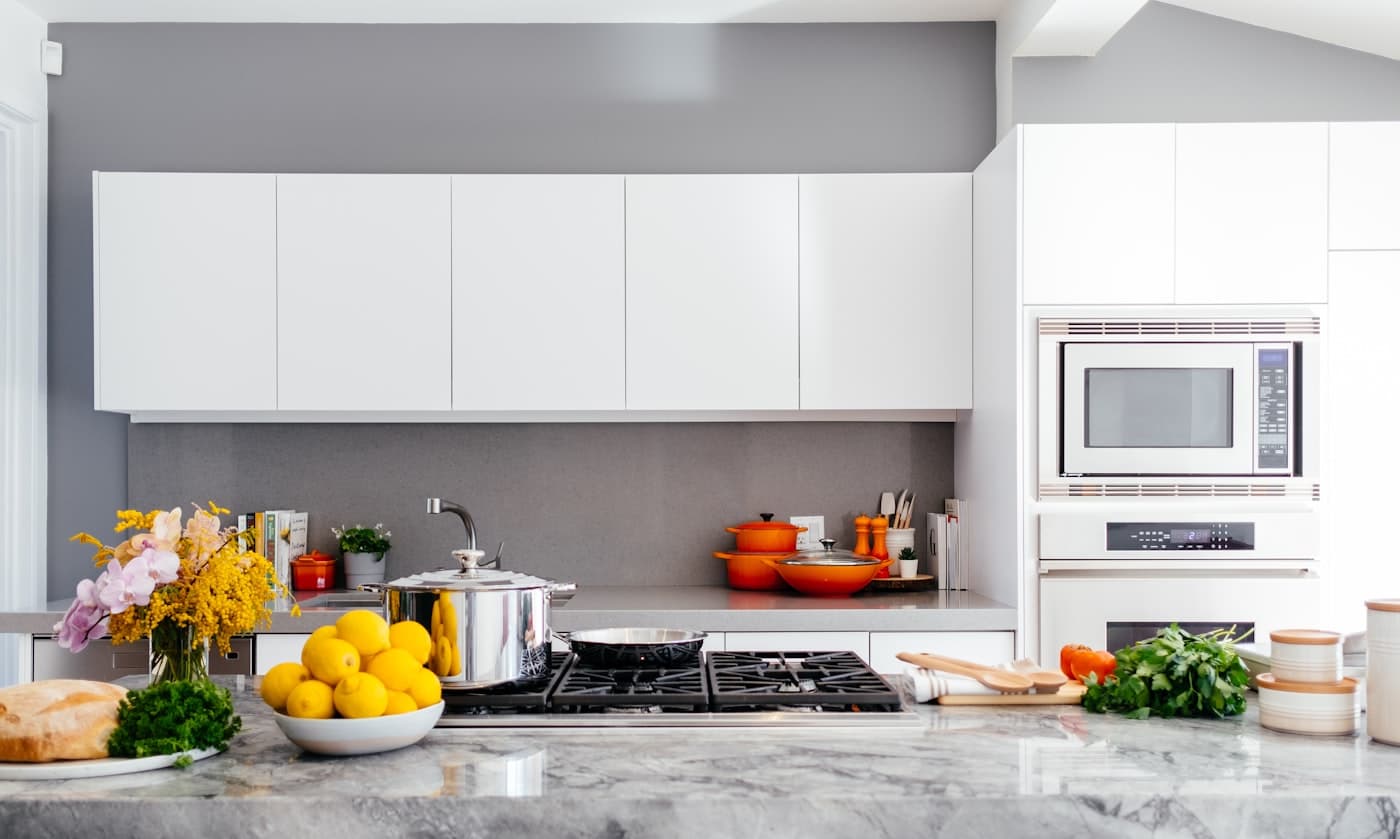 Modern white kitchen remodel with marble countertops